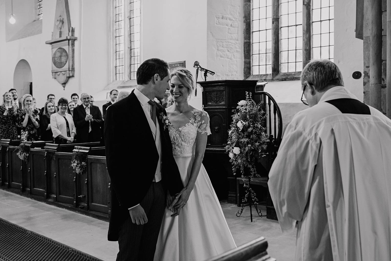 Wedding photography of a couple saying their vows inside Much Wenlock church in Shropshire
