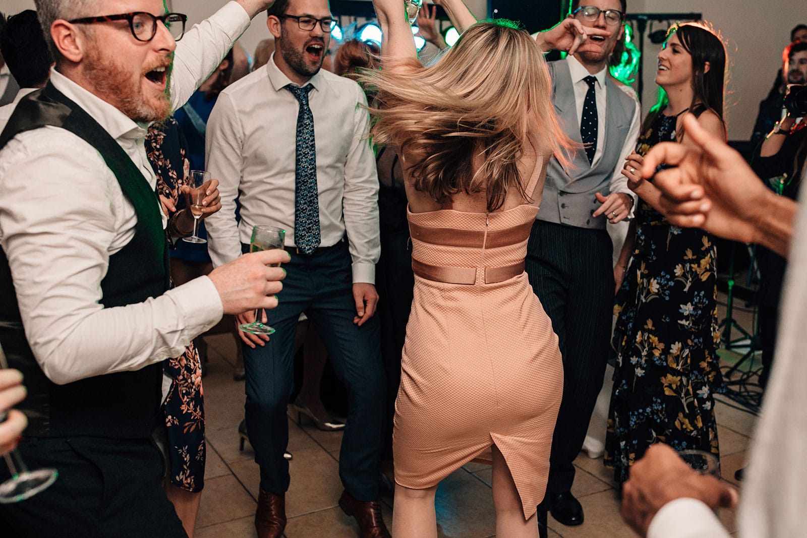Natural and fun photography of wedding guests dancing
