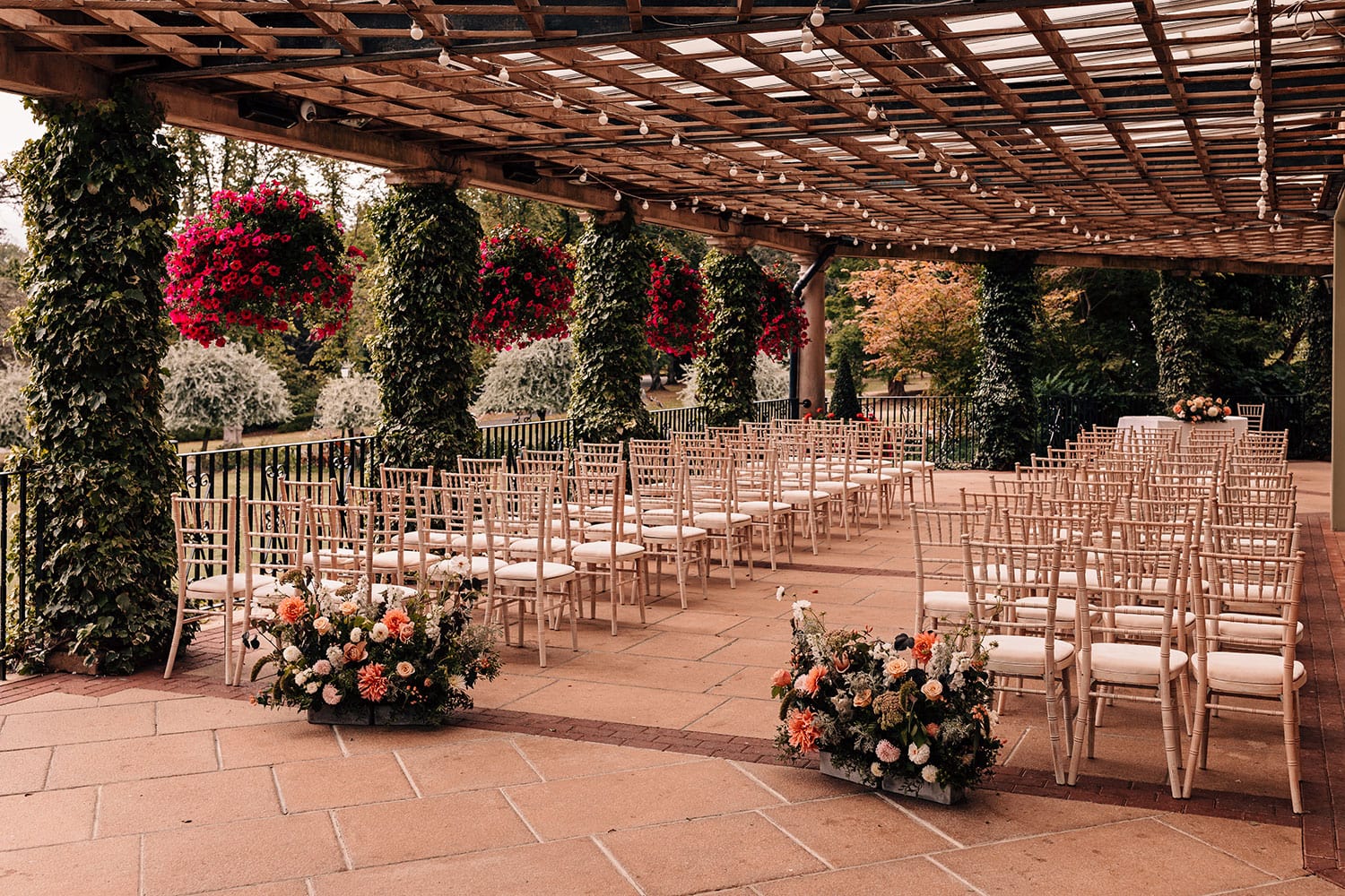 Flowers, greenery and hanging baskets surrounding an outdoor wedding venue in Harrogate