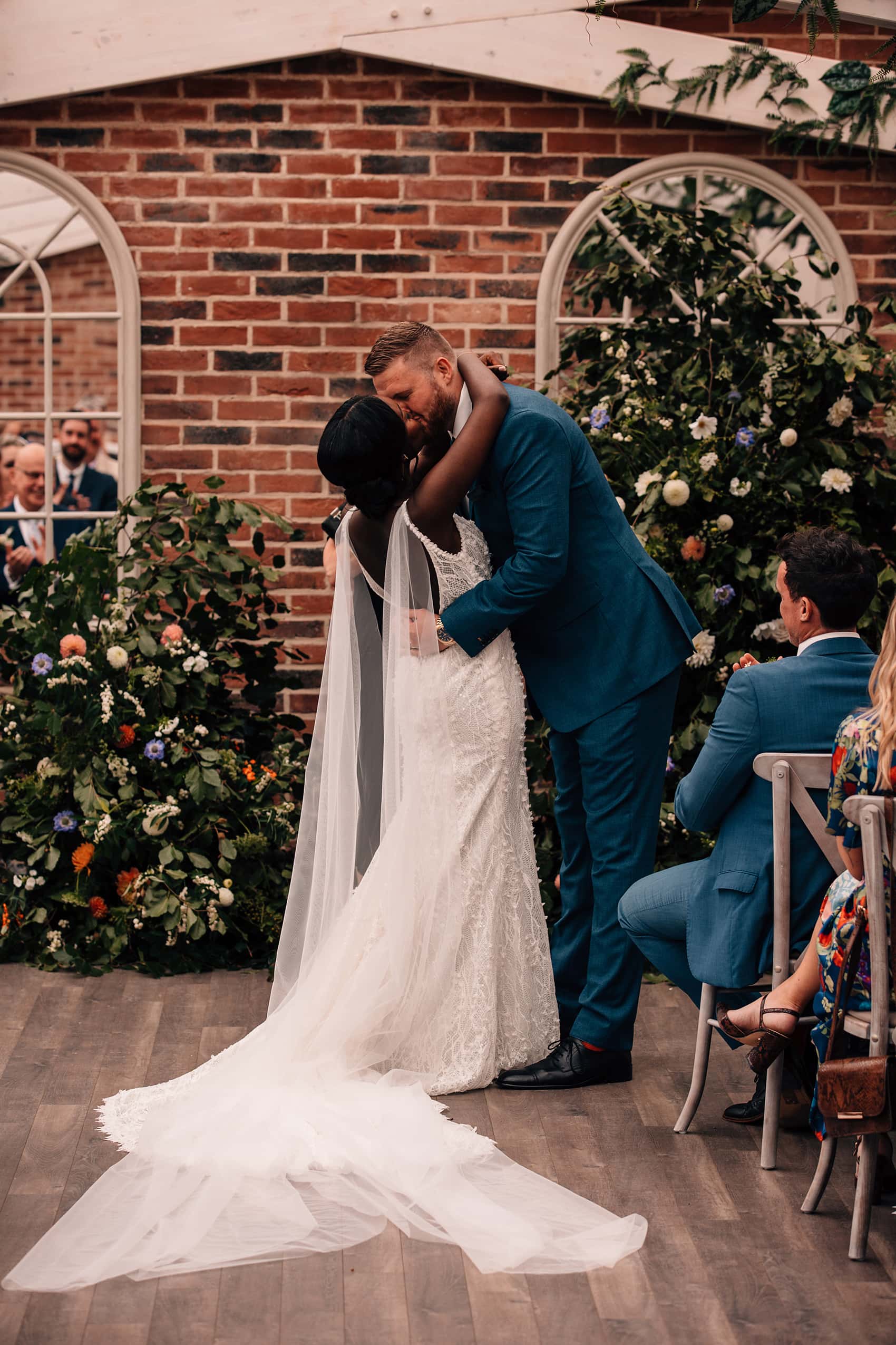 UK wedding photographer bride and groom first kiss