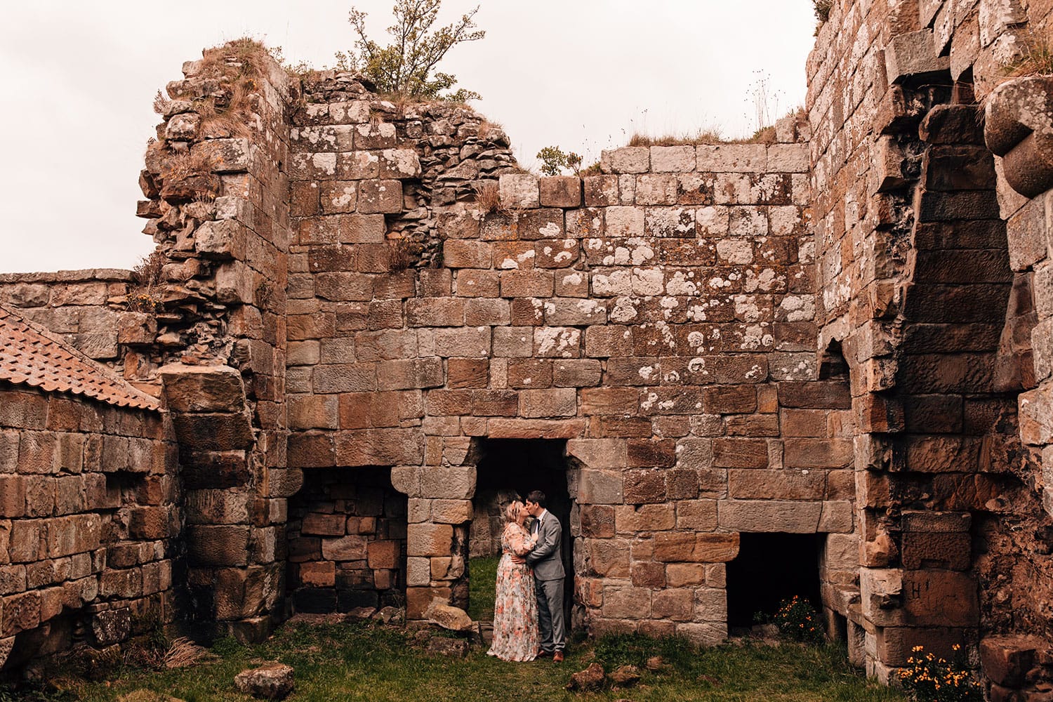 Couple kissing under the Danby Castle ruins