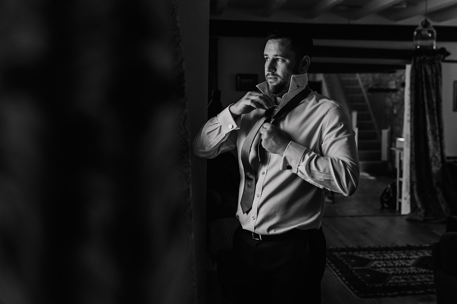 Black and White photograph of a Groom getting ready for his wedding day