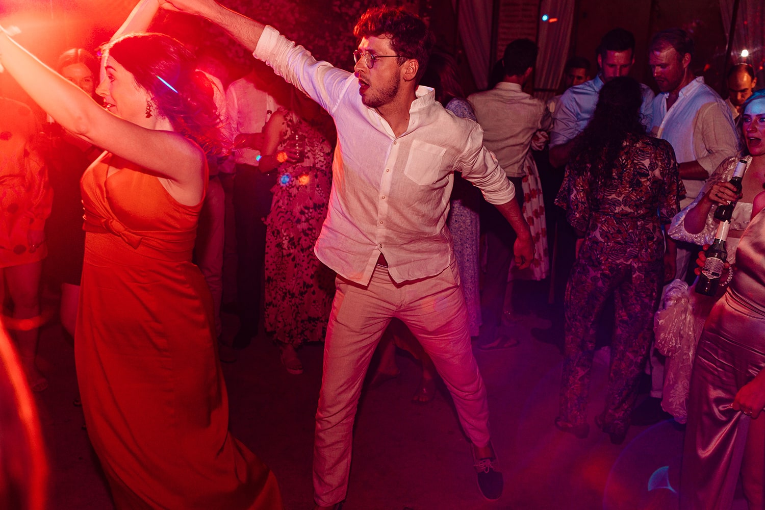 Shutter drag image of two guests dancing at a wedding