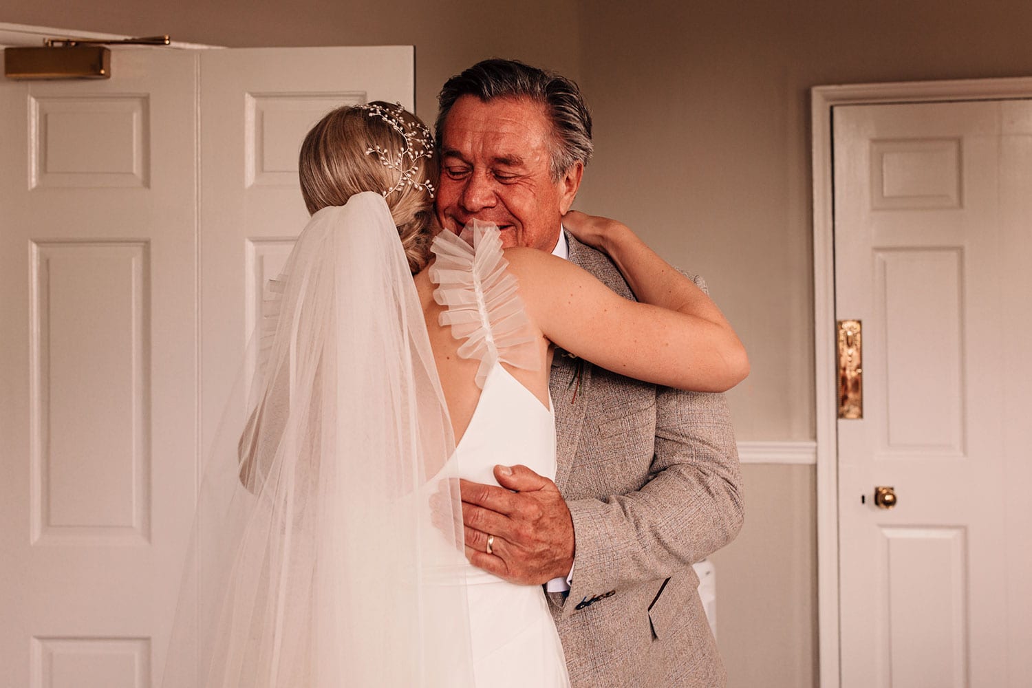 Father seeing his daughter (the bride) in her wedding dress for the first time
